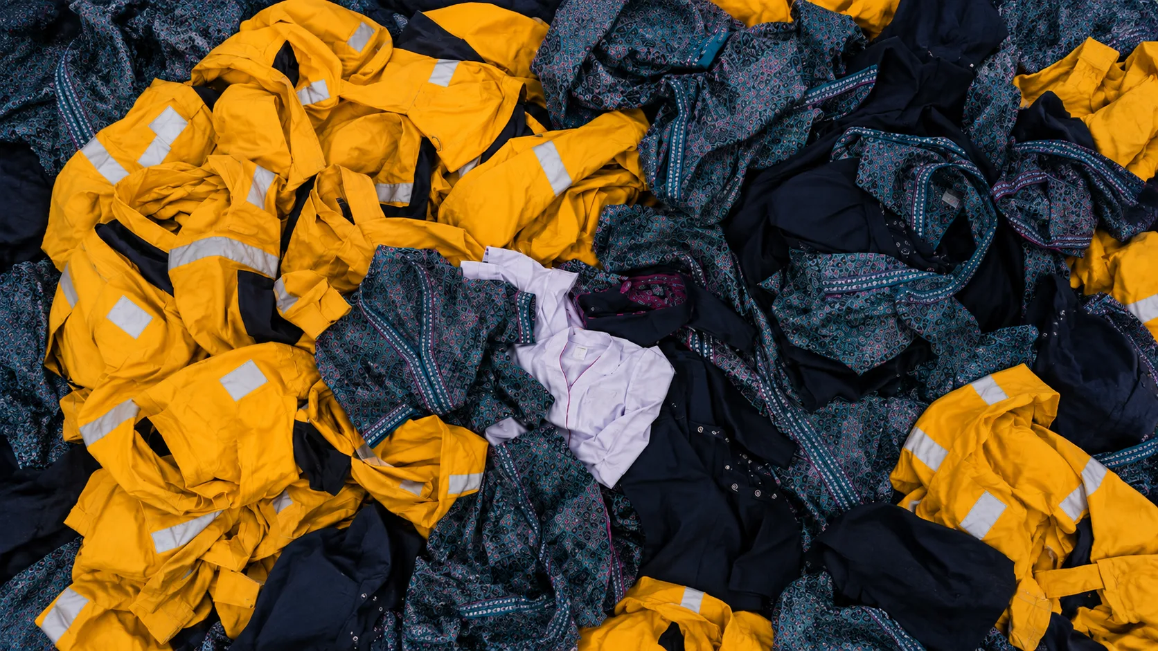 Yellow coveralls and batik uniforms—materials for upcycled corporate gifts Malaysia businesses can create.